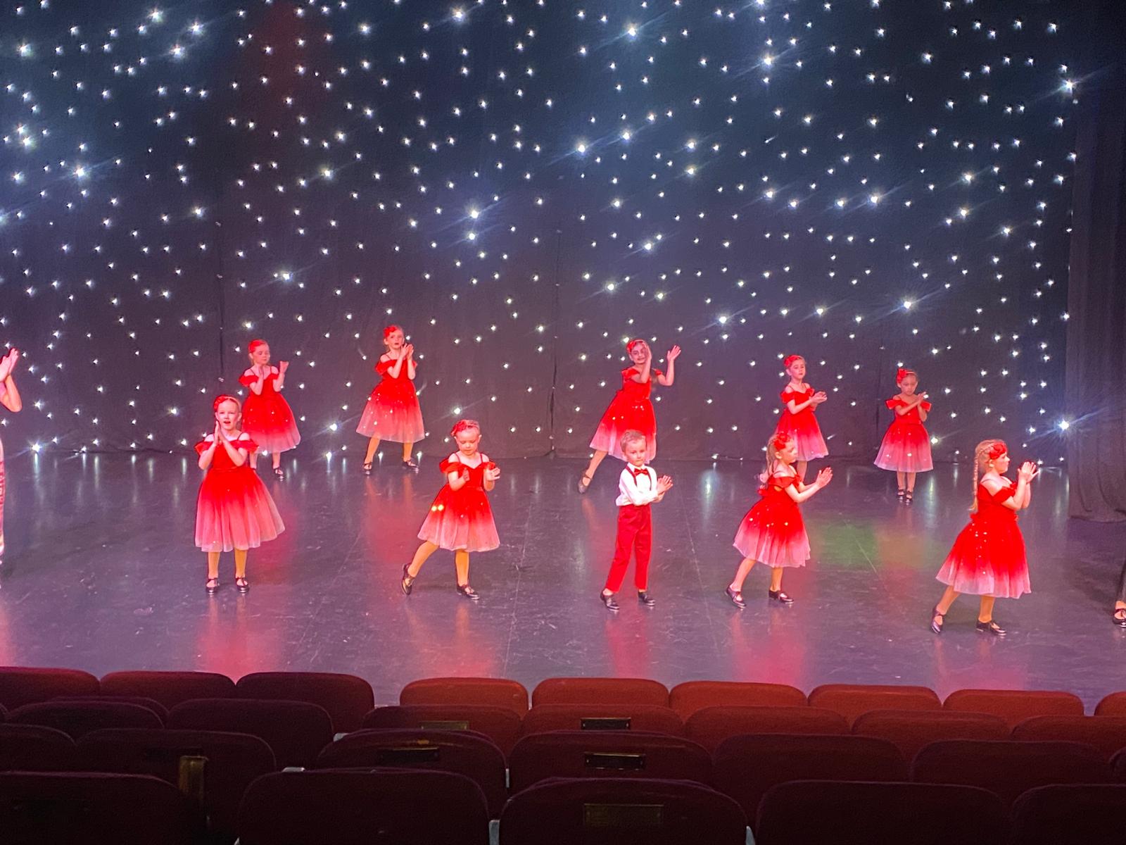 Smiling dancers on stage during show in Bradford
